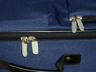 Muted zipper pull tabs