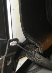 Sound deadening sheet jammed in door spring