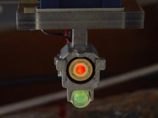 Reflected spot near laser aperture