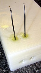 Music wire in epoxy plug