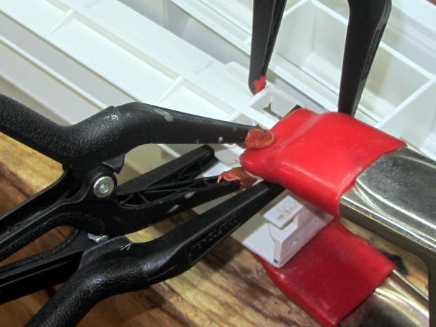 Refrigerator strut - many clamps