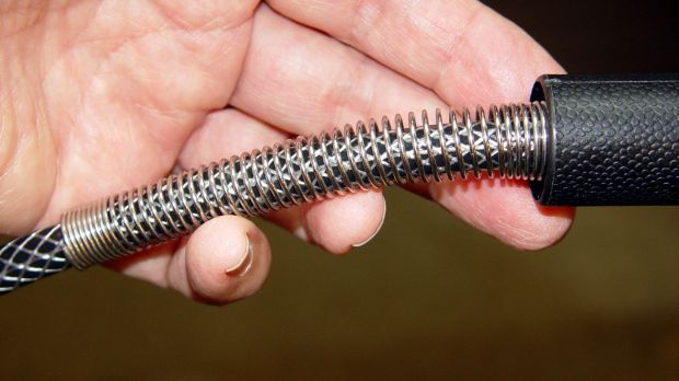 Sprayer hose with kink-resisting spring