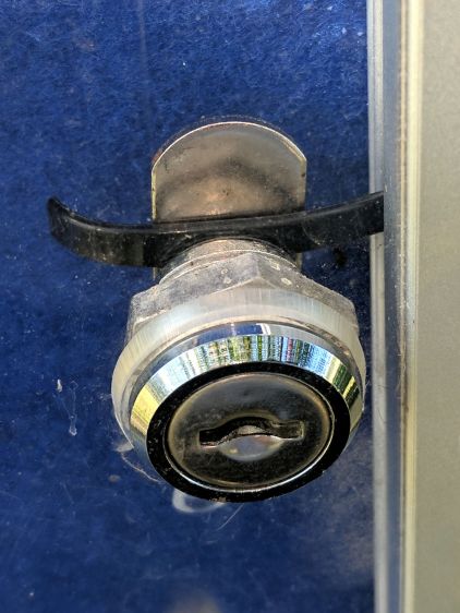 Bulletin Board Lock - improvised strap retainer - front