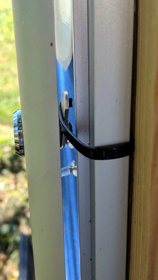 Bulletin Board Lock - improvised strap retainer