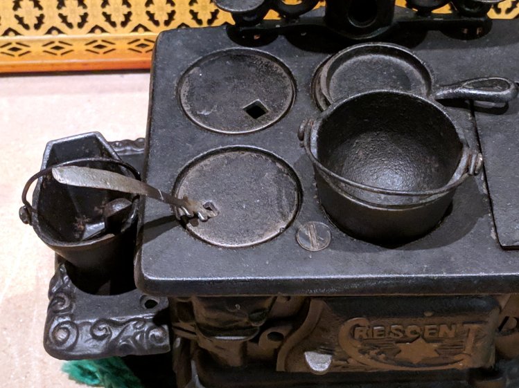 Toy stove with repaired lid lifter